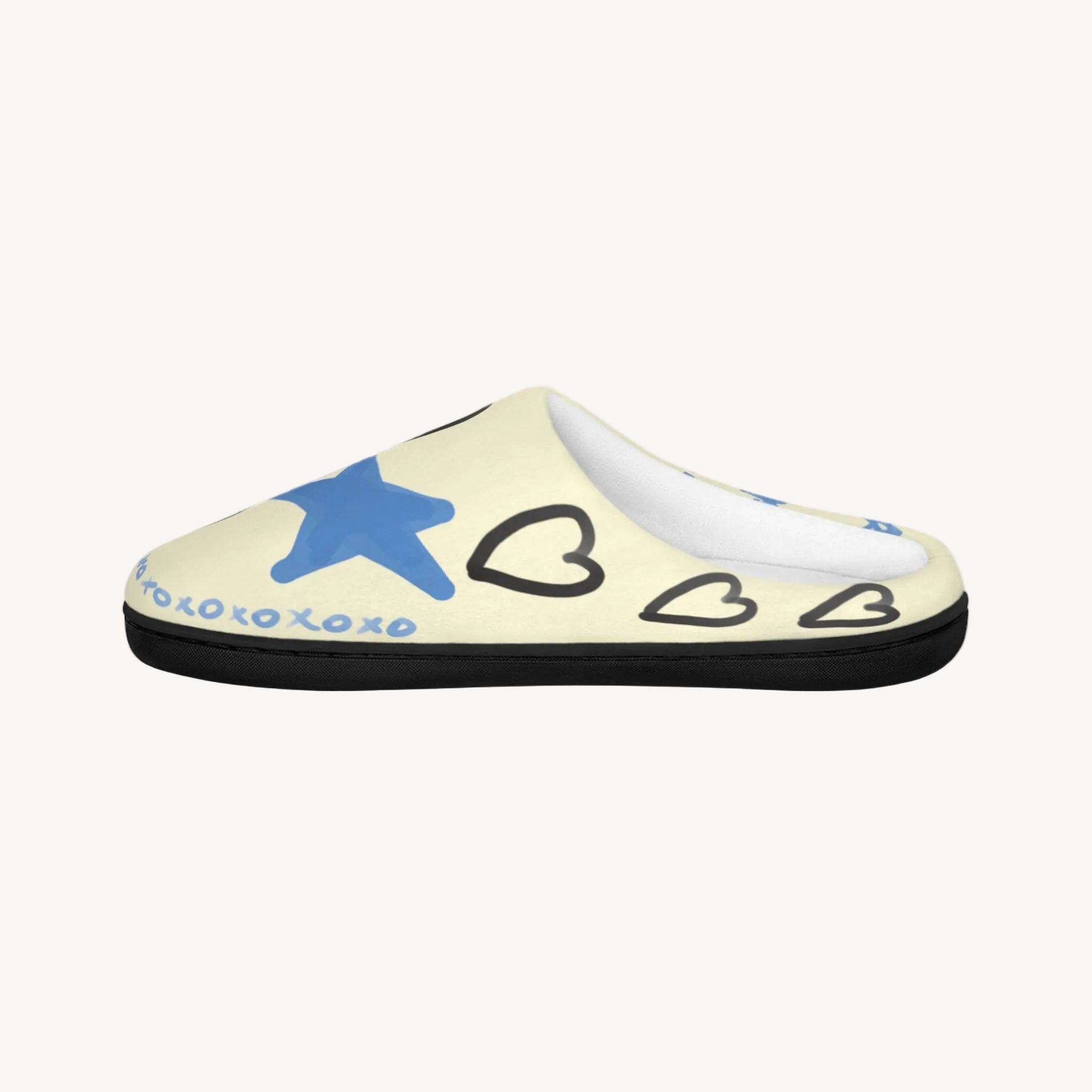 Beige slipper with blue star and black hearts on a white background