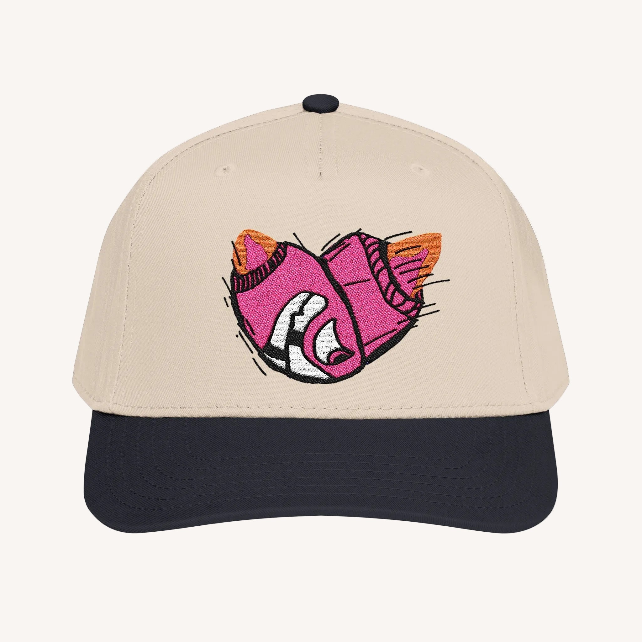 Beige cap with a pink and black Bomb face design on a white background