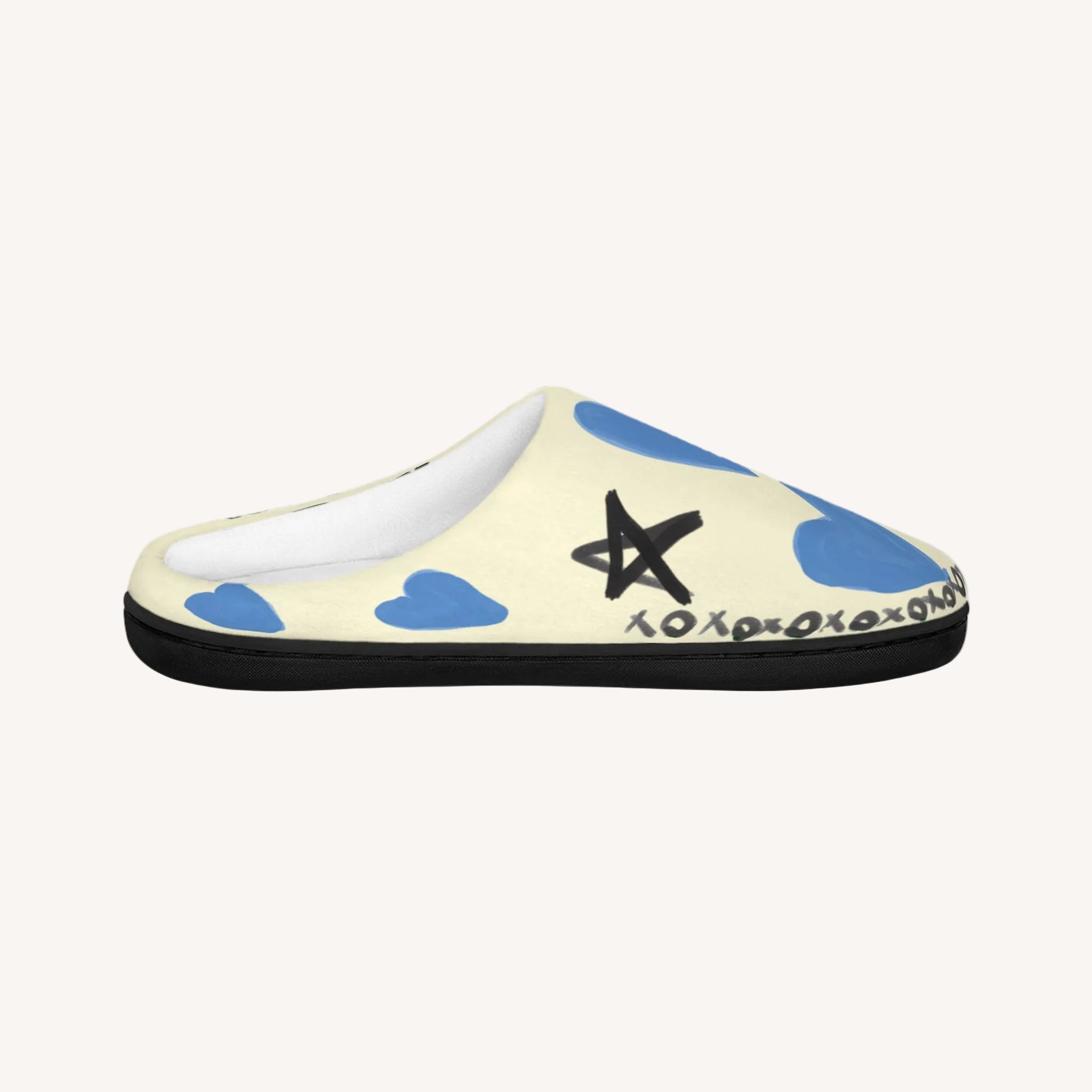 Slipper with blue hearts and a black star design on a white background
