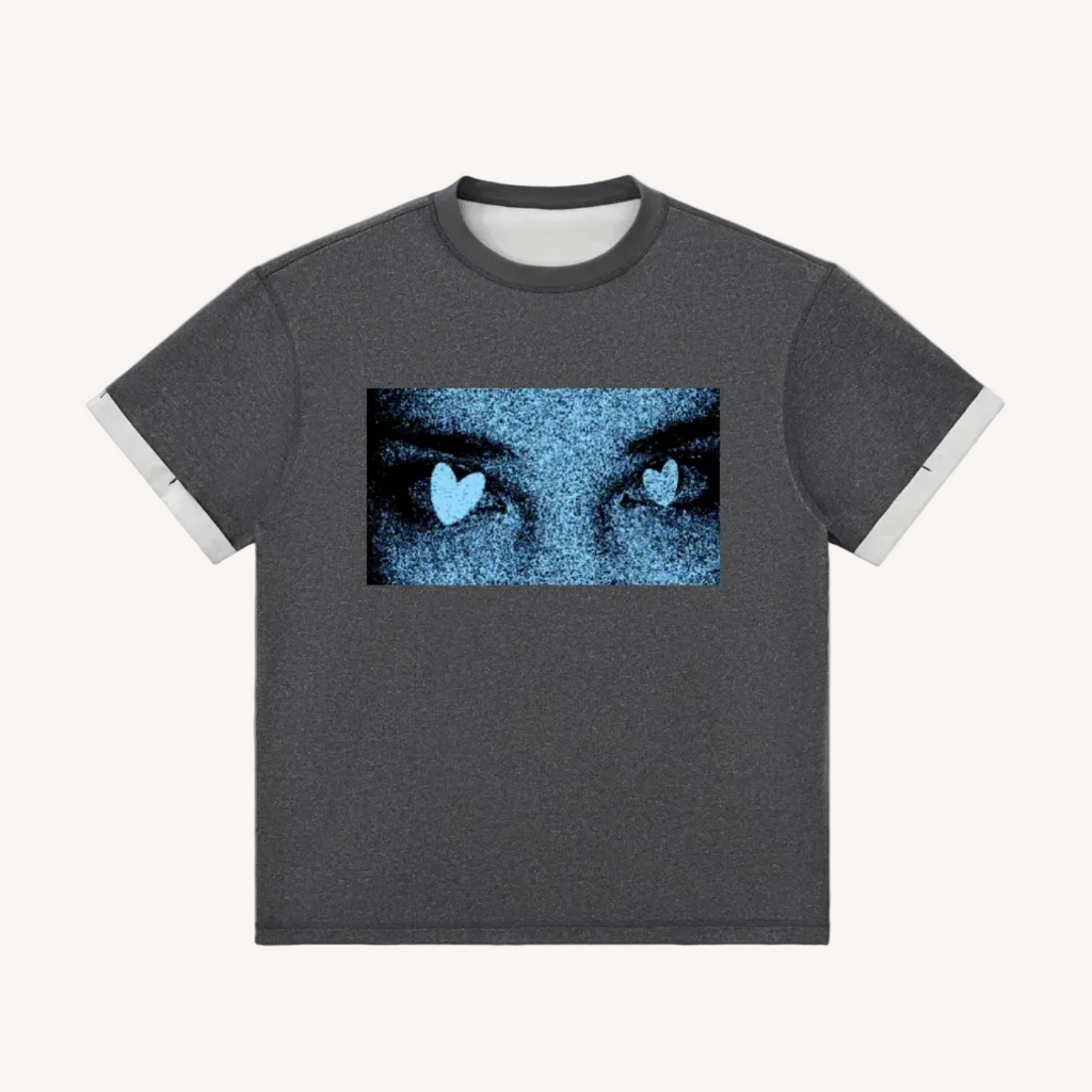 Gray t-shirt with a graphic of eyes with heart shapes on a white background