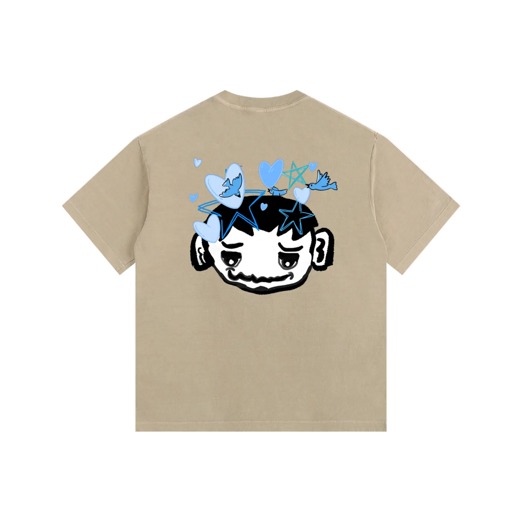 Beige t-shirt with a graphic design on the back featuring a face with closed eyes, blue butterflies, and stars.