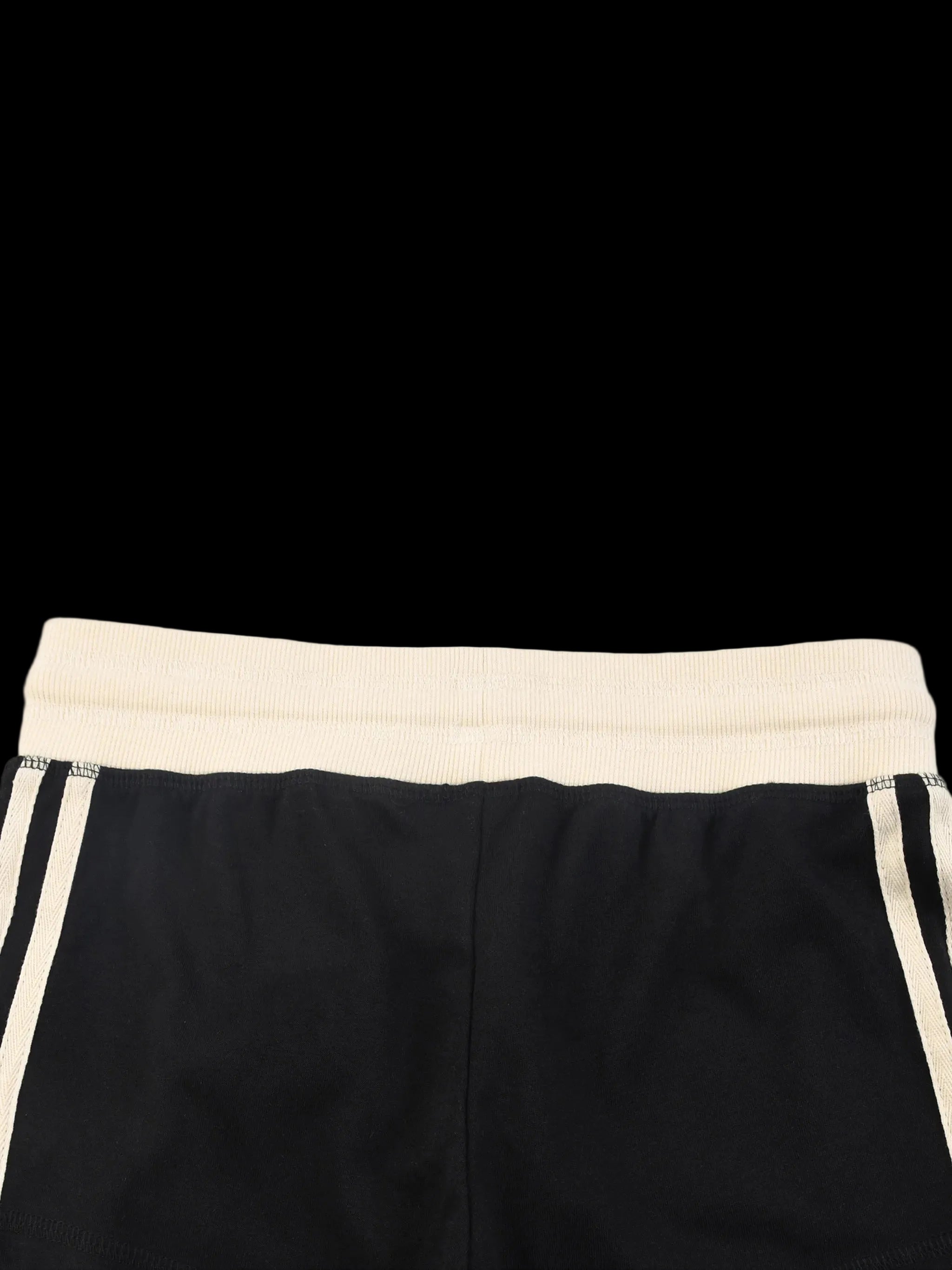 Black shorts with a cream waistband on a white background