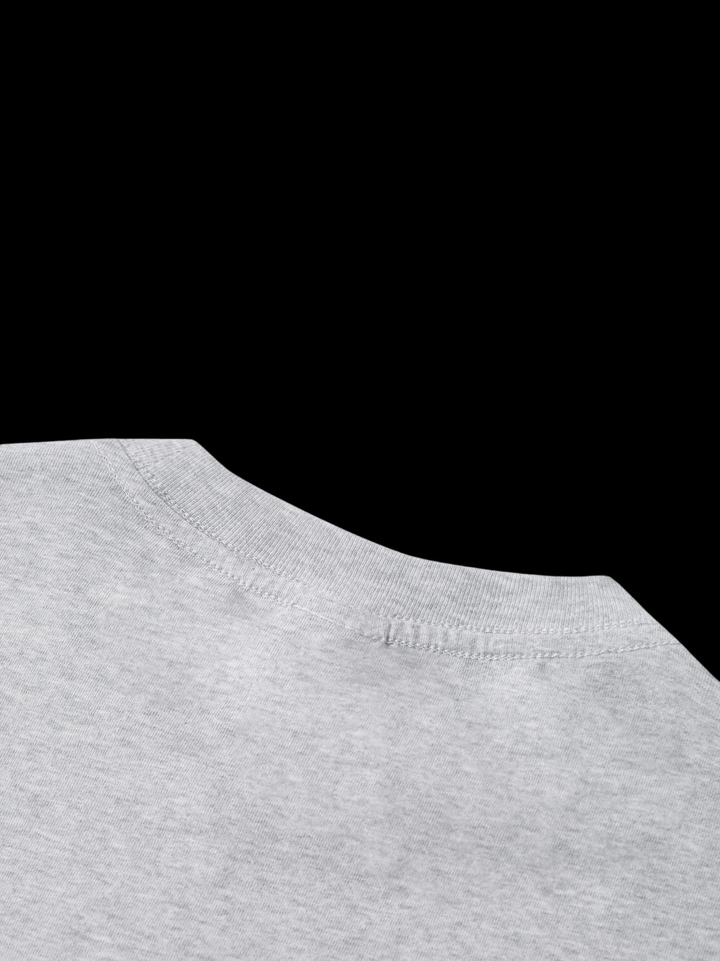 Close-up of a gray shirt collar with a brand logo on a white background